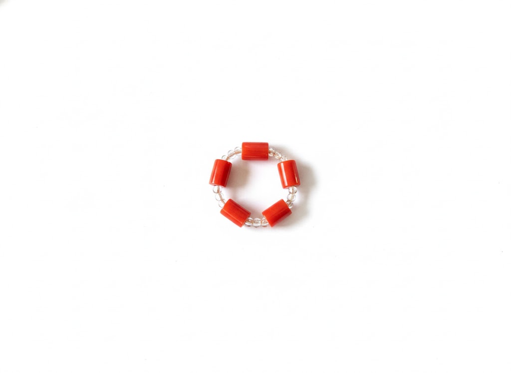 Vibrant coral‑style bead bracelet inspired by West African cultural traditions